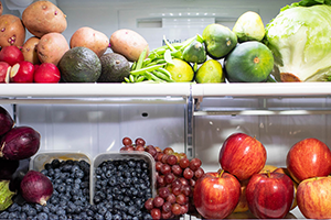 fruits and vegetables piled in fridge